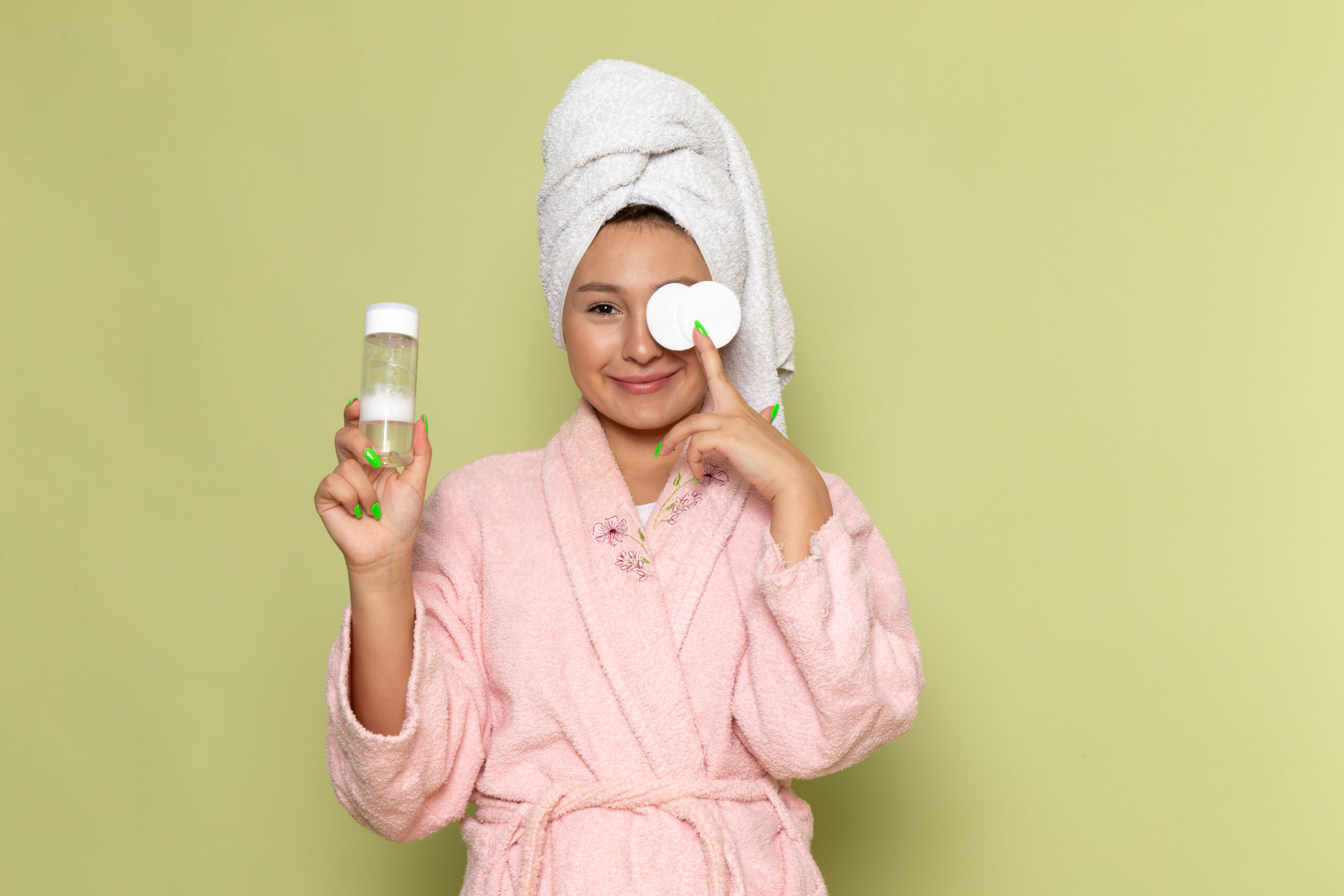 Female pink bathrobe holding little spray